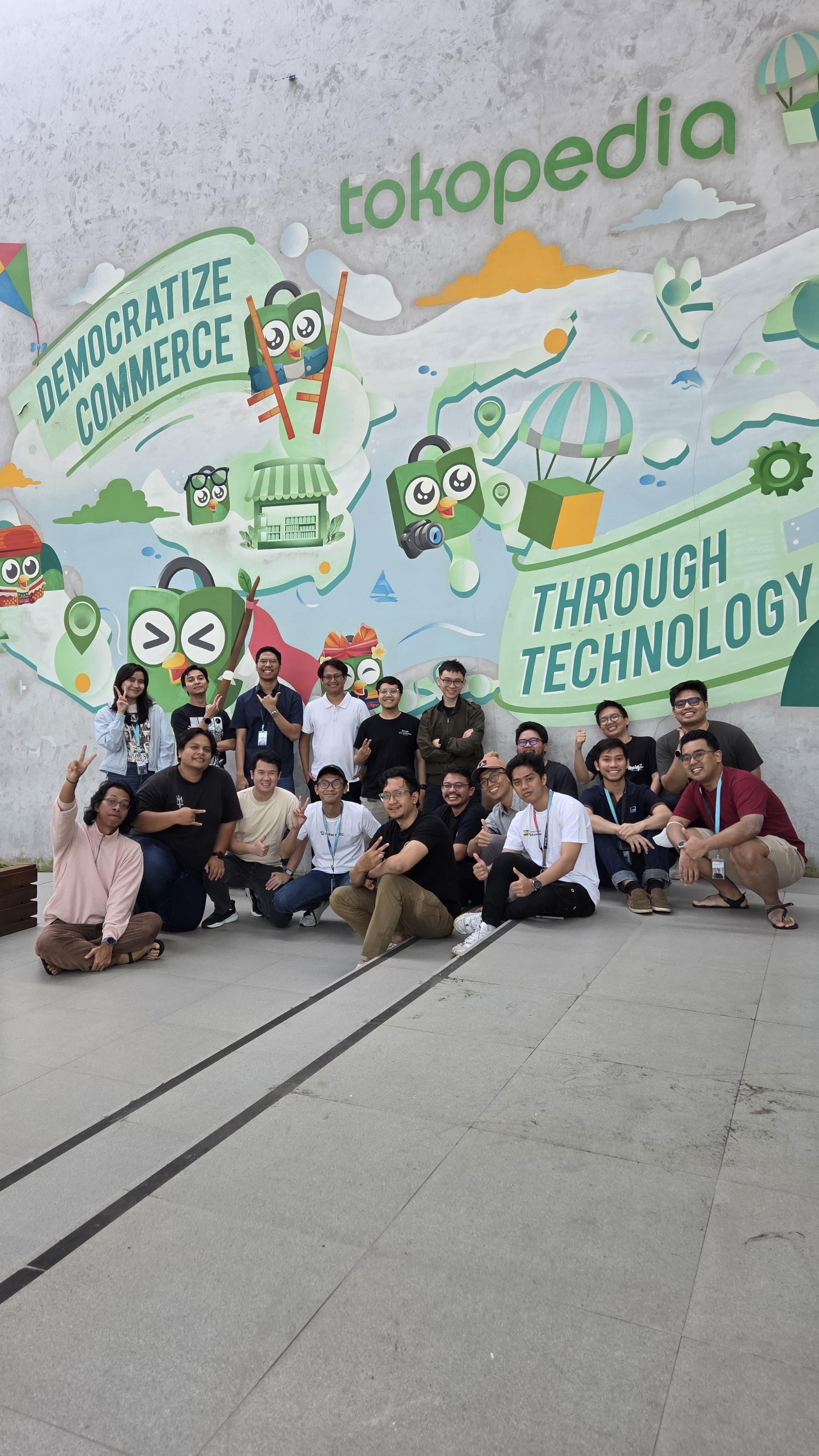 Tokopedia Team in front of the Democratize Commerce Mural